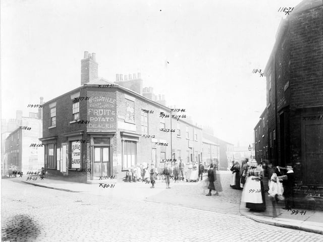 Taken in Waterloo Road looking down Bower Street prior to the Waterloo Road improvements in August 1904.  Bower Street itself contains various residential premises. On Waterloo Road there is W.Savlle, grocers; an advertisement for Jubilee Laundry and Chaplin Hairdressers on the junction with Wales Street. There are many people standing on the road.