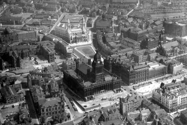 An aerial view of the city centre including Leeds Civic Hall and Leeds Town Hall. In the centre of the left edge the Gothic Revival style frontage of Leeds General Infirmary can be seen, facing onto Great George Street. Continuing right, the Leeds Institute is visible, recognisable by the roof of its centrally positioned circular lecture hall. The block of properties which follow to the left of this development are the Municipal Buildings (1884). These buildings originally housed civic offices along with Leeds Central Library.