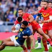 Leeds Rhinos' Kallum Watkins, who played for England in last year's Ashes, is tackled by Catalan Dragons' Zac Lipowicz and Kruise Leeming during last night's game at AMT Headingley which the hosts won 46-4. Picture by Allan McKenzie/SWpix.com.