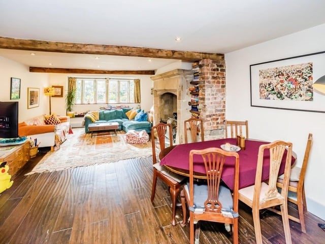 An open plan arrangement with a lounge that flows through to a dining area, which in turn links to the kitchen.