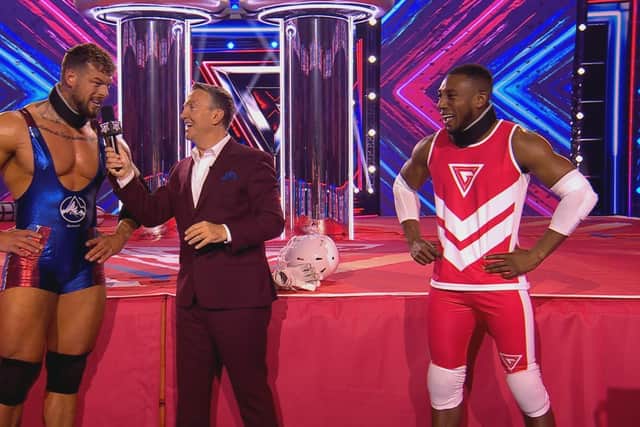 Myles Harris (right) on the show with host Bradley Walsh and one of the new Gladiators named Giant. Photo: BBC