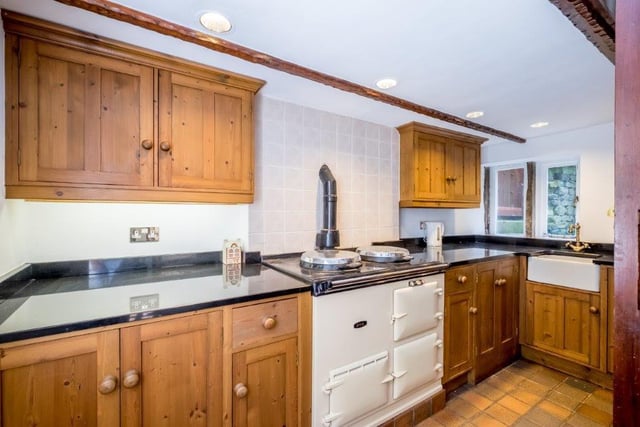 The fitted kitchen has a full range of units and a gas fired AGA stove.