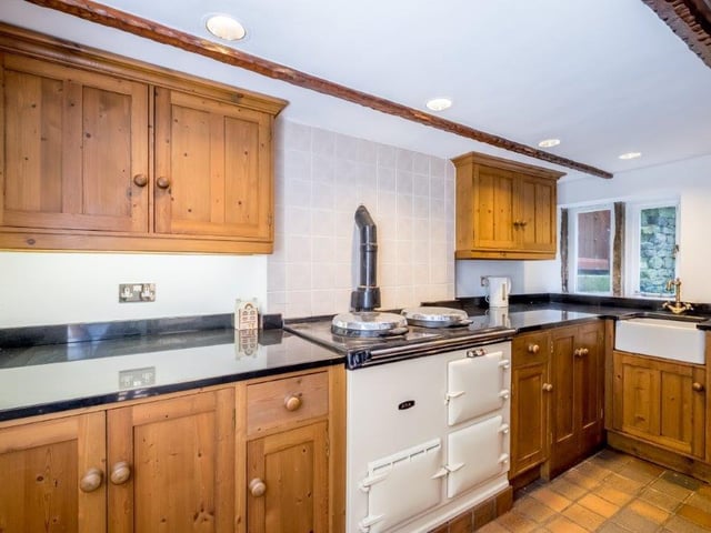 The fitted kitchen has a full range of units and a gas fired AGA stove.