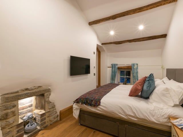 Chance's Well is a two-bedroom holiday cottage with private hot tub and feature glass-covered well in the living room.