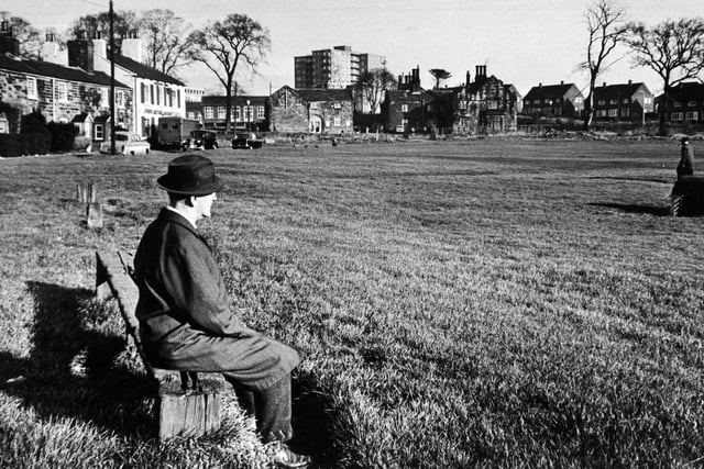 A man enjoy a moment of peace and quiet on The Green in November 1967.
