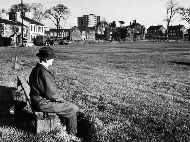 A man enjoy a moment of peace and quiet on The Green in November 1967.
