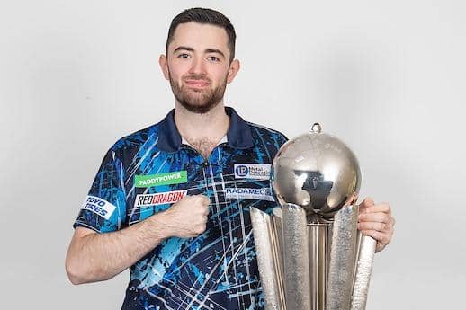 Leeds United fan Luke Humphries with the Paddy Power World Darts trophy. Picture by Taylor Lanning/PDC.