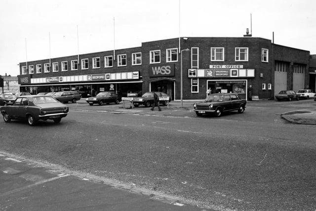 The WASS garage, car showroom on Hunslet Road pictured in march 1980. Dealers in Vauxhall and Bedford vehicles. To the right is a shop which includes a post office facility. WASS was a division of the Wallace Arnold group.