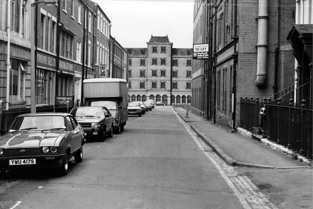 View looking down York Place to Queen Street. The buildings at the end, number 9 to 17 Queen Street, are an architect's drawing, a 'design to site'. It shows the redevelopment which includes a 5 storey office block toilets and an entrance lobby with 12 car parking spaces. Pictured in July 1979.