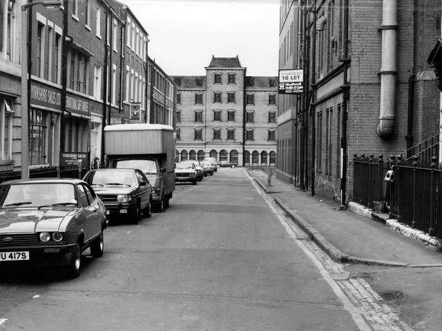 View looking down York Place to Queen Street. The buildings at the end, number 9 to 17 Queen Street, are an architect's drawing, a 'design to site'. It shows the redevelopment which includes a 5 storey office block toilets and an entrance lobby with 12 car parking spaces. Pictured in July 1979.