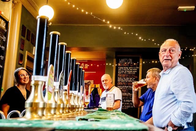 Jo Waude, manager of The Crocketers, and customers at the bar