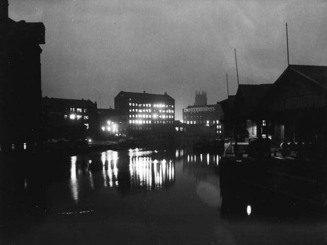 The River Aire by night from Leeds Bridge in November 1960.