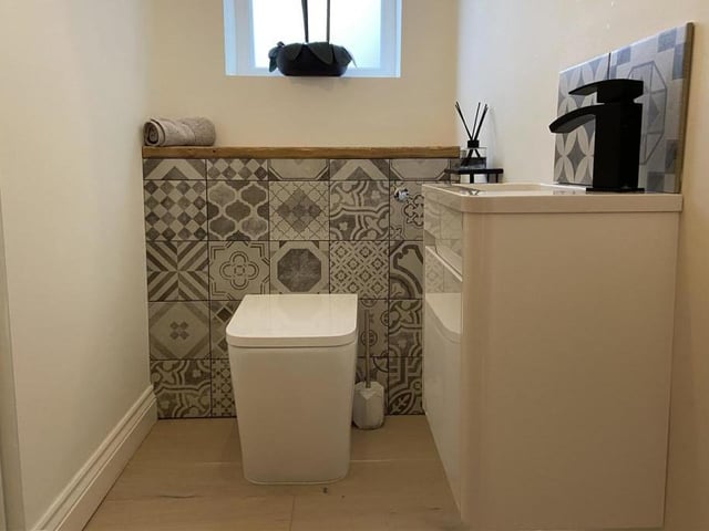 A stylish w.c. with wash basin and vanity unit.