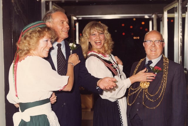 The Lord Mayors of the twinned cities of Leeds and Dortmund are pictured receiving carnation boutonnieres from two ladies dressed in German national costume. This was at an evening event in September 1980 organised during Dortmund Week in the restaurant of Lewis's department store on The Headrow. Dortmund Week was held to celebrate 10 years of twinship between Leeds and Dortmund. The Lord Mayor of Dortmund, or Oberburgermeister, Gunter Samtlebe is on the left and the Lord Mayor of Leeds, Coun Eric Atkinson MBE is seen, right.