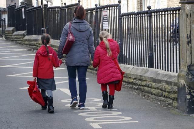 File photo dated 13/03/20 of children leaving a school in Leeds. The Government has announced its child poverty strategy.