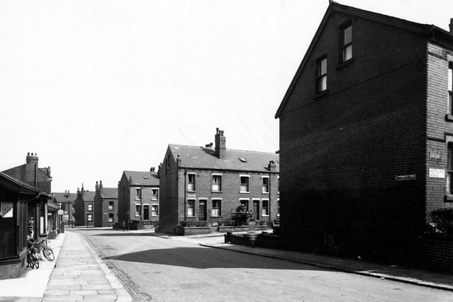 Looking east along Rowland Road in August 1949. Gable ends of Westbourne avenue and Westbourne Place. Bicycles leaning up on left.