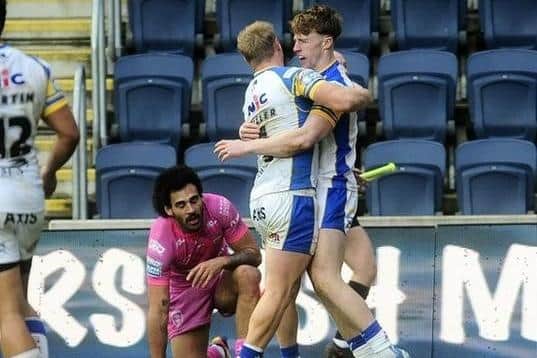 Ned McCormack, right, celebrates his try agianst Hull KR with Leeds Rhinos teammate Lachie Miller. Picture by Steve Riding.
