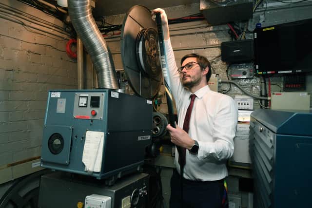 Gary Benn holding a film reel. (Pic credit: Jonathan Gawthorpe)