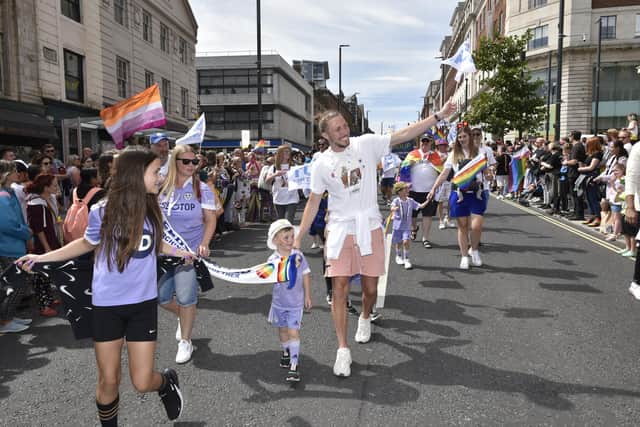 'IMMENSE' SUPPORT: Leeds United star Luke Ayling waves to the massive crowds that lined the streets of Leeds as he takes part in the 2022 Leeds Pride parade with Marching Out Together. Picture by Steve Riding.
