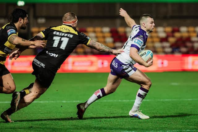 Max Jowitt  is tackled by Josh Griffin during Wakefield Trinity's win at York Knights. Picture by Alex Whitehead/SWpix.com.