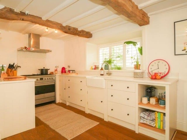 The kitchen has a good range of modern base units with a Smeg range cooker, integrated extractor hood, electric oven and gas hob, Belfast sink with mixer tap and a floor hatch leading to a cellar.