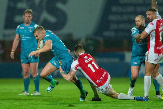 Rhinos debutant Luke Hooley is stopped by Frankie Halton. Picture by Bruce Rollinson.