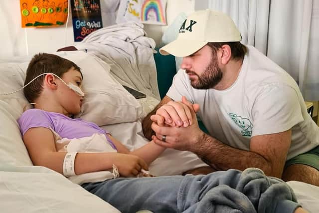 Ben at Louis' bedside in hospital.