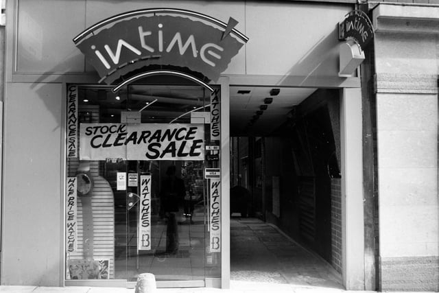 Intime Jewellers on Lands Lane pictured in April 1989. Posters advertise a stock clearance sale with watches at half price. A passageway on the right leads to the back of the shop.