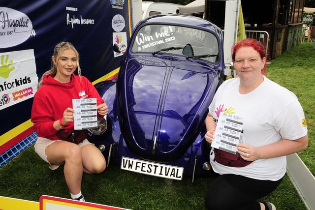 Hannah Clark, left, charity fundraiser executive for Pulse 1, and Paula Clayton, volunteer for Hallam FM, by the Beetle which is being raffled for Cash For Kids.