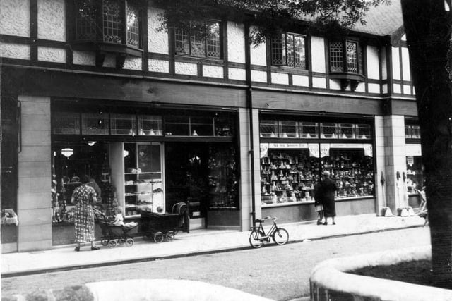 Customers can be seen admiring window displays at the Leeds Industrial Co-operative Society store on Harrogate Road.  Prams and a bicycle can be seen. Pictured in July 1936.