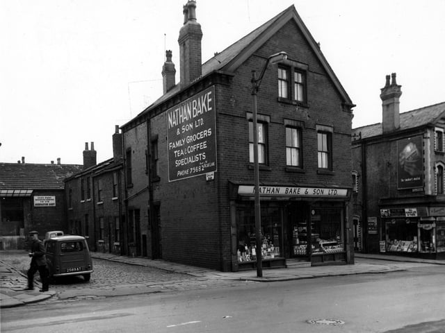 Beeston Road with the junction of Sutcliffe Street on the left, showing the premises of Leeds Paint Manufacturers Company Ltd at Gem Works. Far right on the junction of Kiln Street is R. Fiddes, newsagents, fancy goods, toys and sweets. Pictured in July 1964.