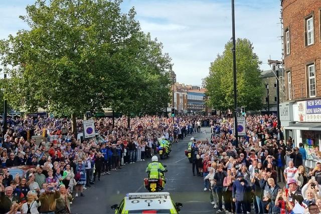 Fans line the streets.