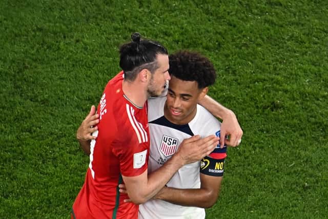 HONOURS EVEN - Leeds United man Tyler Adams with his fellow captain, Gareth Bale of Wales after a 1-1 draw in the World Cup in Qatar. Brenden Aaronson and Daniel James also featured in the game. Pic: Getty