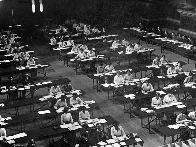 Inside Leeds Town Hall showing students of Leeds University engaged in National Registration work during the First World War. An Act was passed in July 1915 requiring all persons to be registered between the ages of 15 and 65. This was to aid in the recruitment and also assess the available work force. The work was organised by the Registrar General within each Local Authority. Here students have been employed to help with the administration. The results of the scheme were available by mid-September 1915.