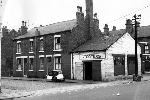 The garage with 'scooters' sign was part of Leeds Motor Exchange. The street on the right is Ashfield Terrace. This is looking from Cambridge Road. Pictured in August 1967.