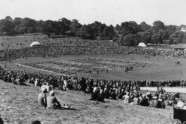 Spectators watch a display of physical education drill at the arena area in Roundhay Park on Children's Day in 1928.