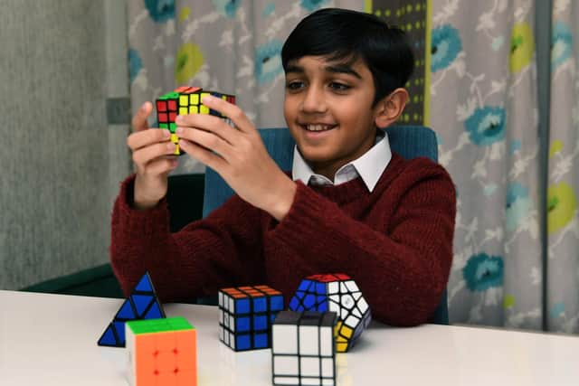 Yusuf Shah playing with his rubrik's cubes. Picture: Jonathan Gawthorpe