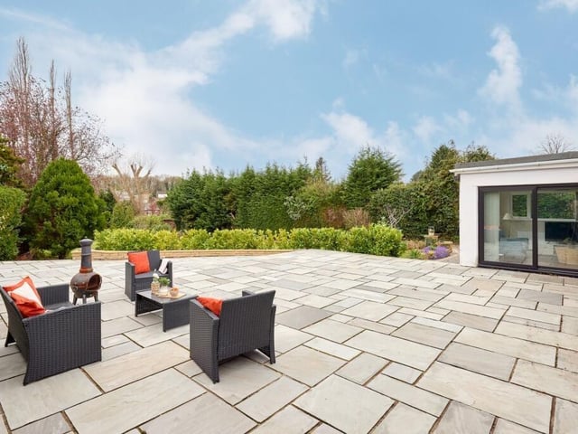 Externally, there is an Indian stone patio with ample room for seating, dining or even a hot tub.