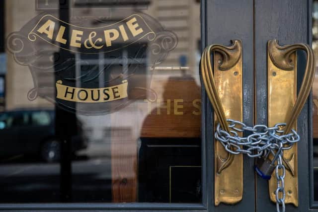 A lock and chain placed across an entrance to a closed pub in London (Photo: Chris J Ratcliffe/Getty Images)