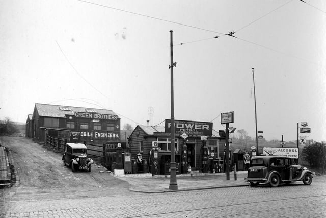 Green Brothers motor engineers on Commercial Road pictured in April 1937. Shows petrol kiosk with pumps to front and workshops accessible via mud track.