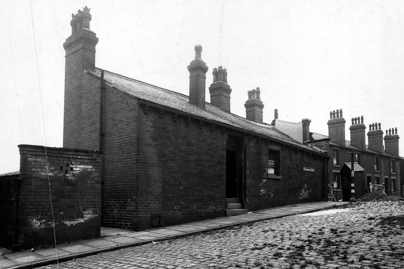 A view looking north at number 1 Rosebank Row onto Rosebank Road. "Road stopped" sign and a workman's hut in the background. Pictured in August 1944.