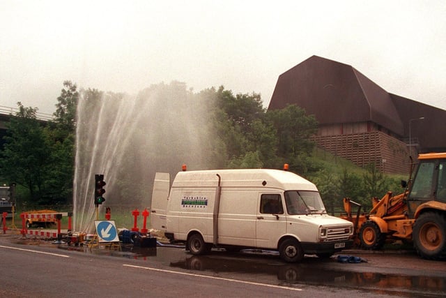 A burst pipe sends out jets of water on the Pontefract to Knottingley road in June 1997 as workmen wait for the mains to be turned off to begin repair work