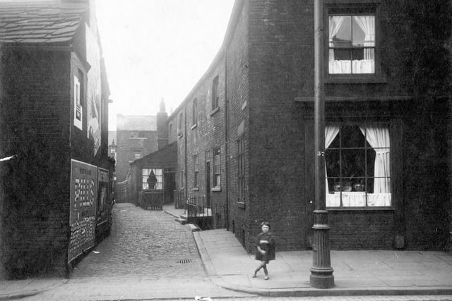 A child is stood at the entrance to Taylor's yard on Low Road in August 1929.