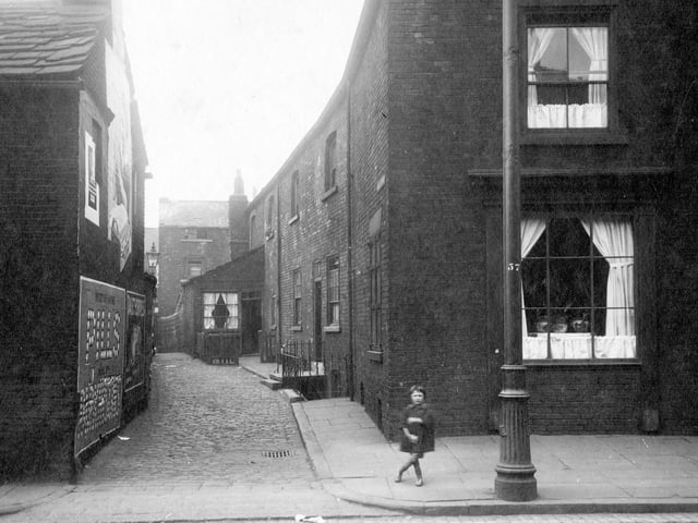 A child is stood at the entrance to Taylor's yard on Low Road in August 1929.
