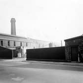 The premises of Catton & Co of 29 Chadwick Street who were steel casting manufacturers. The premises has a high wall, yard and various buildings. There is a tall chimney behind the building. Pictured in September 1951.