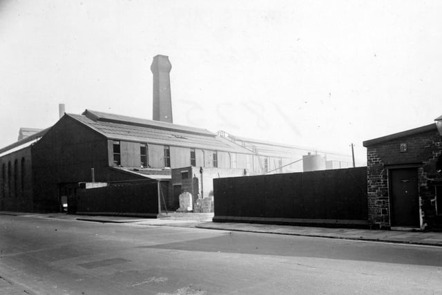 The premises of Catton & Co of 29 Chadwick Street who were steel casting manufacturers. The premises has a high wall, yard and various buildings. There is a tall chimney behind the building. Pictured in September 1951.