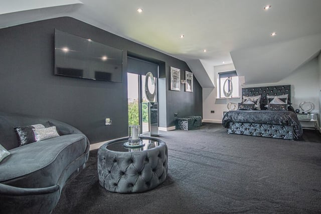 A large and super stylish bedroom with access outdoors.