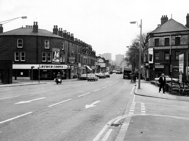 Roundhay Road seen from the junction with Gathorne Terrace, right. On the left is the curved frontage of Arthur Cooper, Wine Merchant at number 142 Roundhay Road. The photograph is taken looking in the direction of the City Centre. The left turn leads into Roseville Road.
