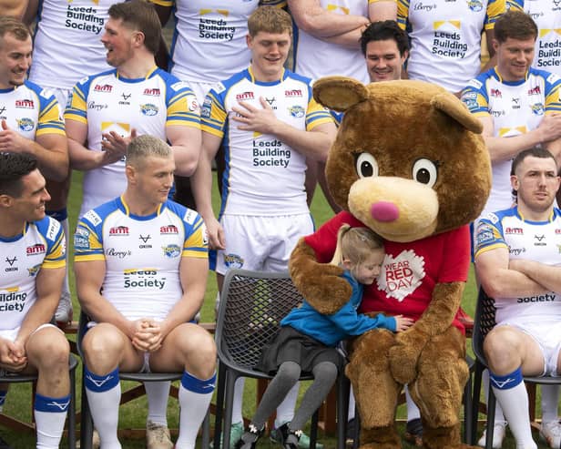 Little fan Elsie Payne, aged five, gives Children’s Heart Surgery Fund mascot Katie Bear a cuddle during Leeds Rhinos' photocall at AMT Headingley. Picture by Simon Hulme