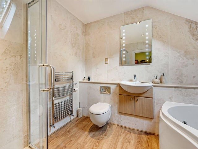 The en-suite bathroom comes complete with both a jacuzzi bath and shower.